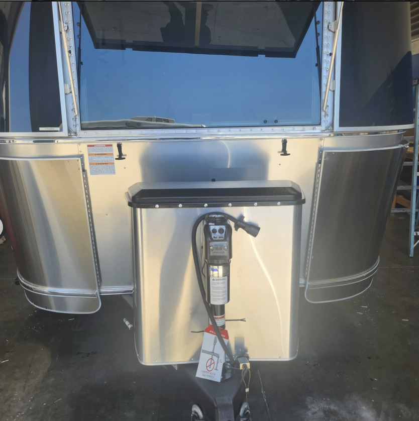 Front of a modern Airstream with aluminum battery box and tongue jack